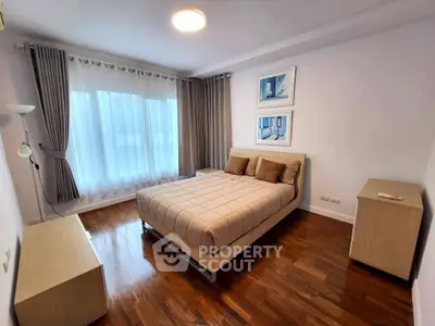 Elegant bedroom with modern decor and large window for natural light