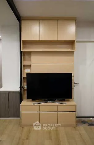 Modern living room with sleek wooden TV cabinet and flat-screen TV