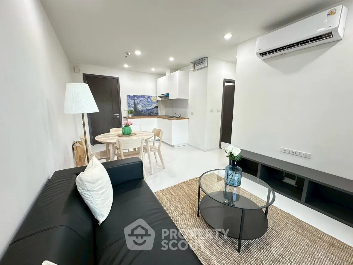 Modern living room with sleek furniture and open kitchen layout