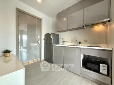Modern kitchen with sleek cabinets and appliances in a stylish apartment