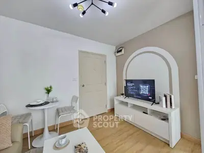 Modern living room with stylish decor and TV setup, perfect for relaxation.