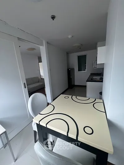 Modern apartment interior with stylish kitchen and dining area, featuring sleek design and contemporary furniture.