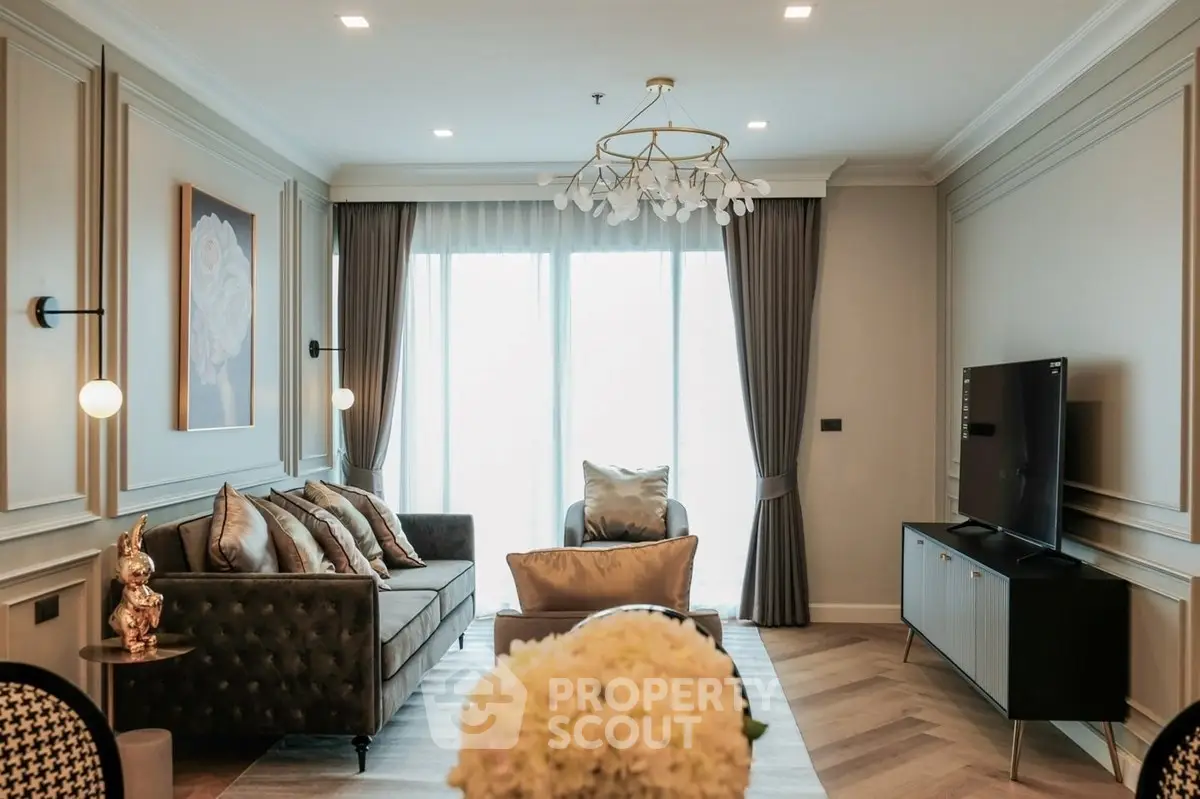 Elegant living room with modern decor, large windows, and stylish lighting fixtures.