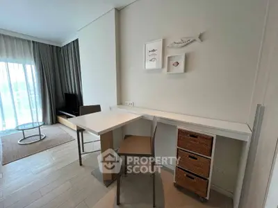Modern living room with stylish furniture and natural light, featuring a cozy seating area and elegant decor.