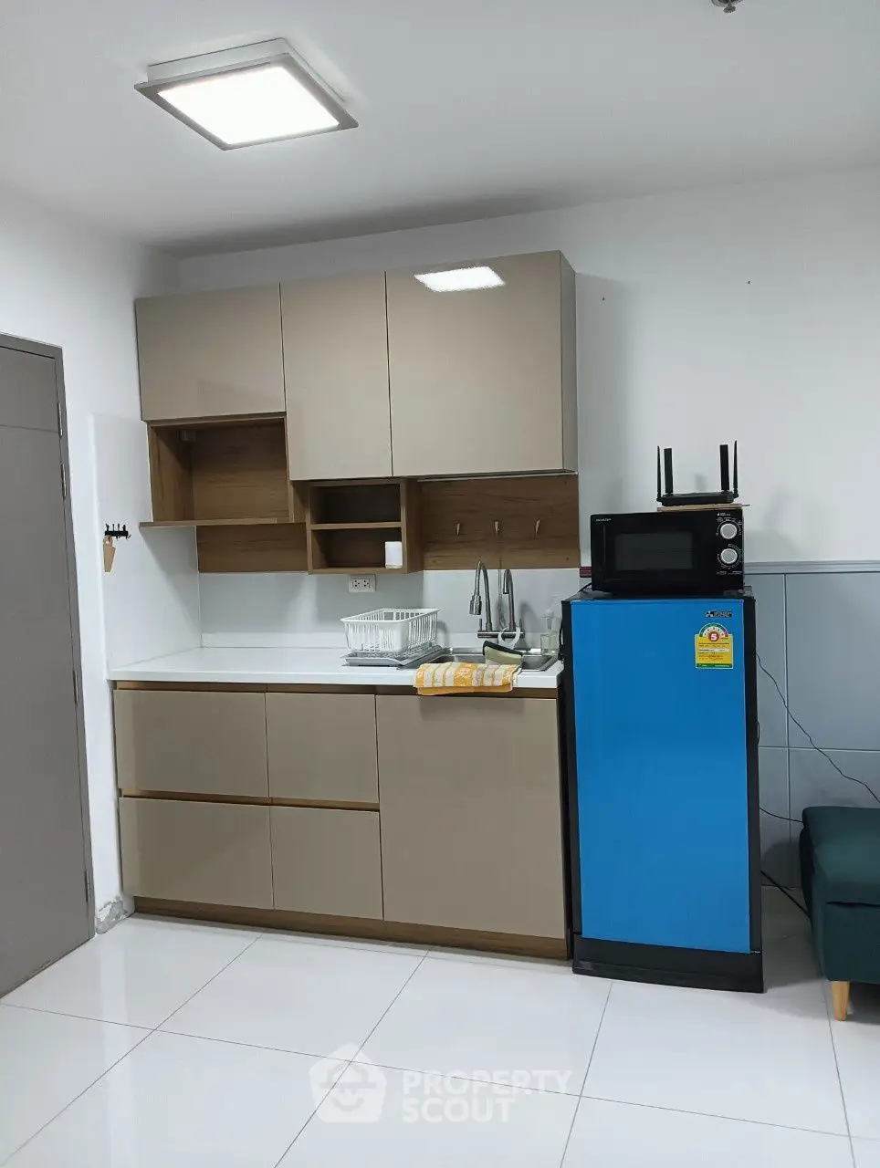 Modern compact kitchen with sleek cabinets and appliances, ideal for urban living.