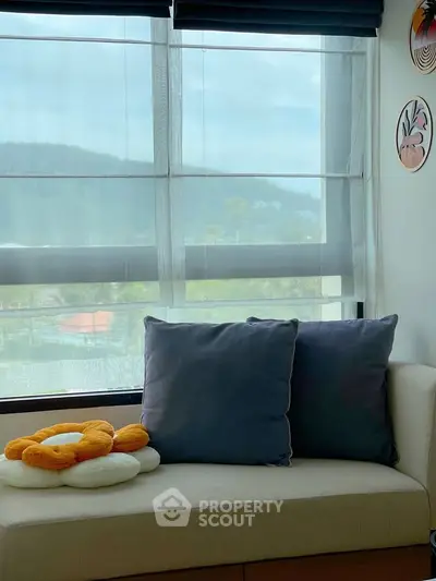 Cozy living room corner with plush sofa and scenic window view