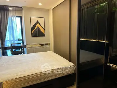 Modern bedroom with stylish decor and large window offering natural light