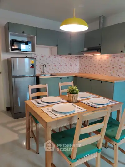 Charming kitchen with modern appliances and cozy dining area, perfect for family meals.