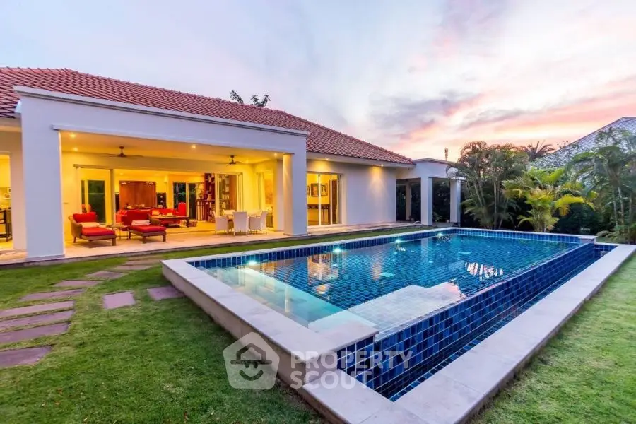 Luxurious villa with stunning pool and open living area at sunset