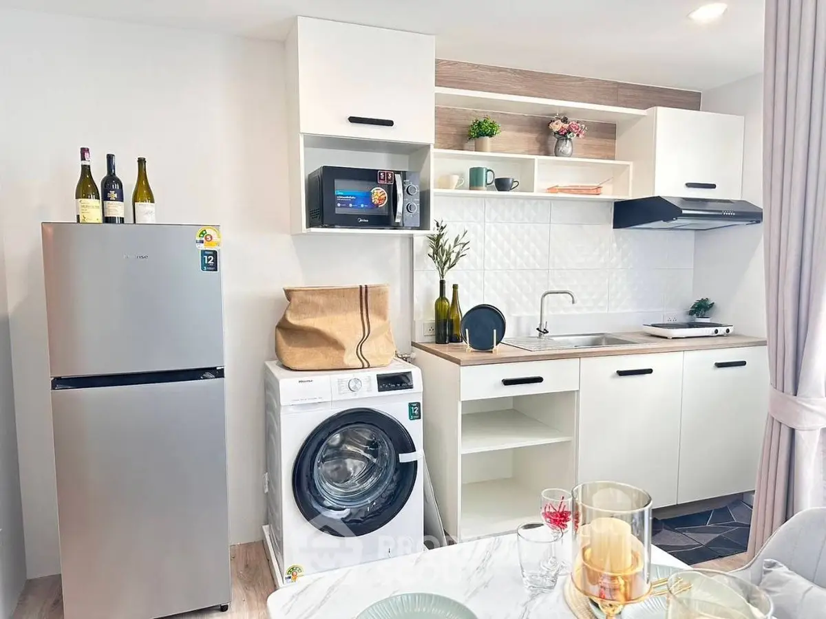 Modern kitchen with washing machine and sleek appliances in stylish apartment