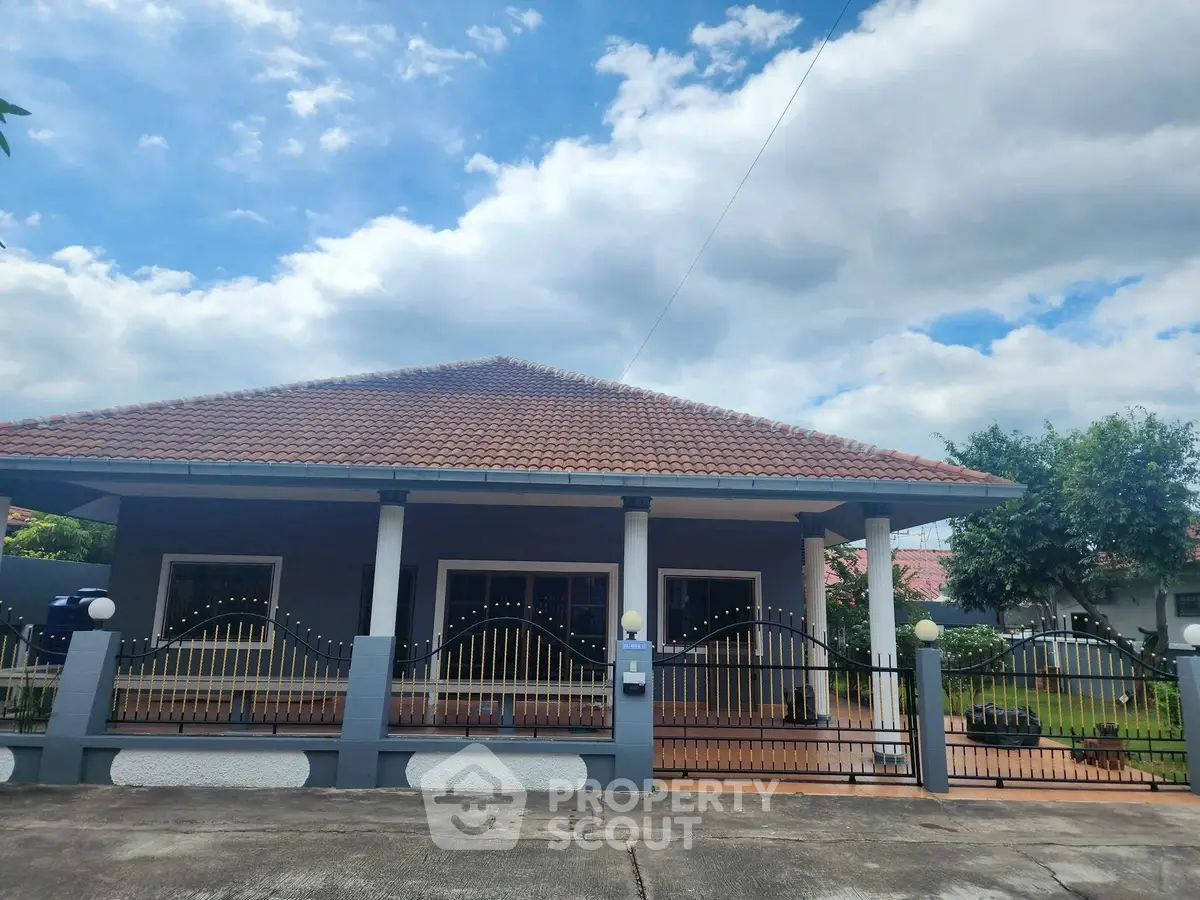 Charming single-story home with tiled roof and spacious front yard