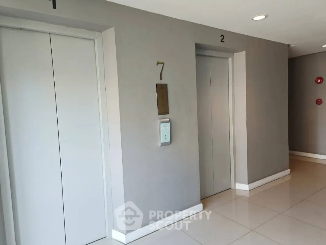 Modern elevator lobby with sleek design and neutral tones on the seventh floor.