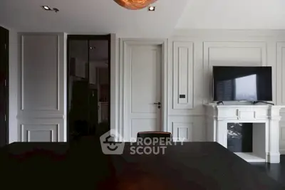 Elegant living room with modern TV setup and stylish paneling