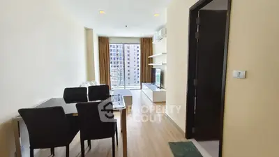 Modern living room with dining area and balcony view in a high-rise apartment.