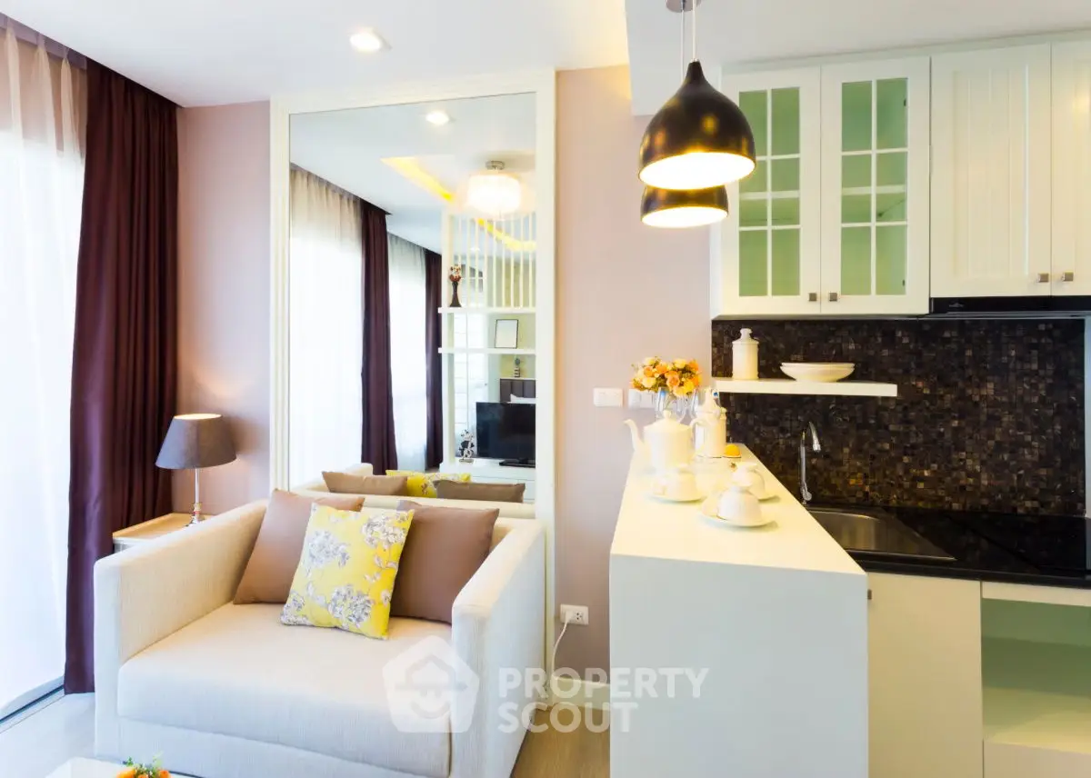 Modern open-layout living room with stylish kitchen and cozy seating area.