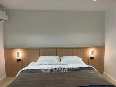Modern bedroom with cozy lighting and elegant wooden headboard