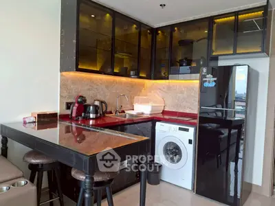 Modern kitchen with sleek black cabinets and built-in appliances
