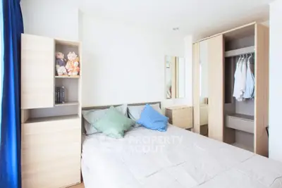 Bright and airy bedroom with a large comfortable bed, built-in wardrobe, and a full-length mirror, perfect for modern living.