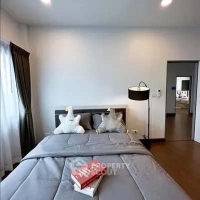 Cozy bedroom with stylish decor and plush bedding in modern apartment