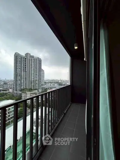 Spacious balcony with city view in modern high-rise apartment