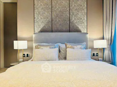 Luxurious bedroom with elegant decor and plush bedding in modern apartment.