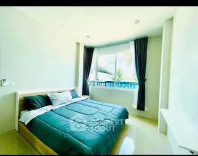 Bright and airy bedroom with large window and modern decor