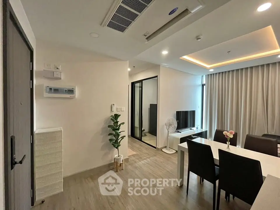 Modern living room with dining area and stylish decor in a contemporary apartment.