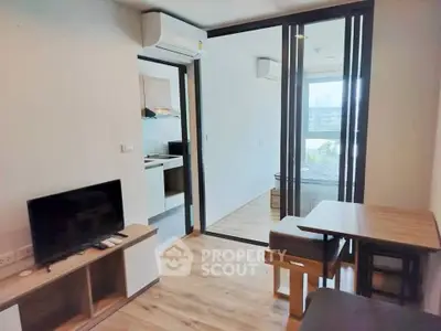 Modern living room with open kitchen and sleek wooden flooring