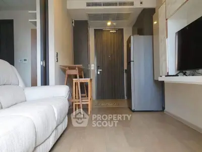Modern apartment interior with cozy living area and sleek kitchen appliances.