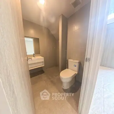 Modern bathroom with sleek design and contemporary fixtures in a real estate property.