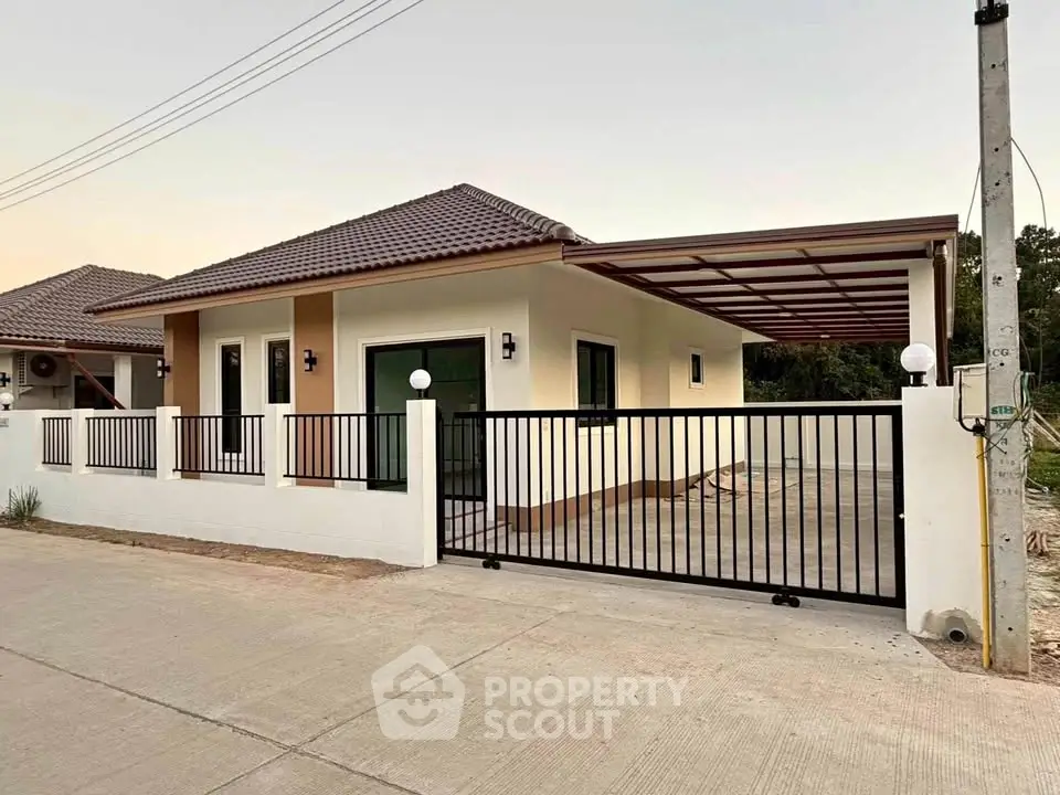 Charming single-story home with modern gate and spacious driveway