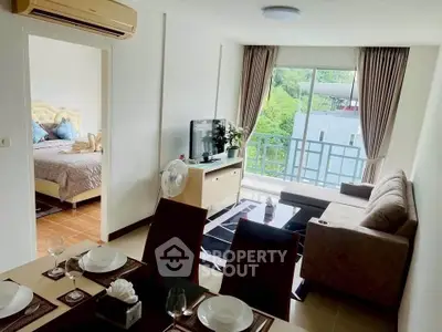 Modern living room with balcony view, open layout, and stylish decor in a cozy apartment.