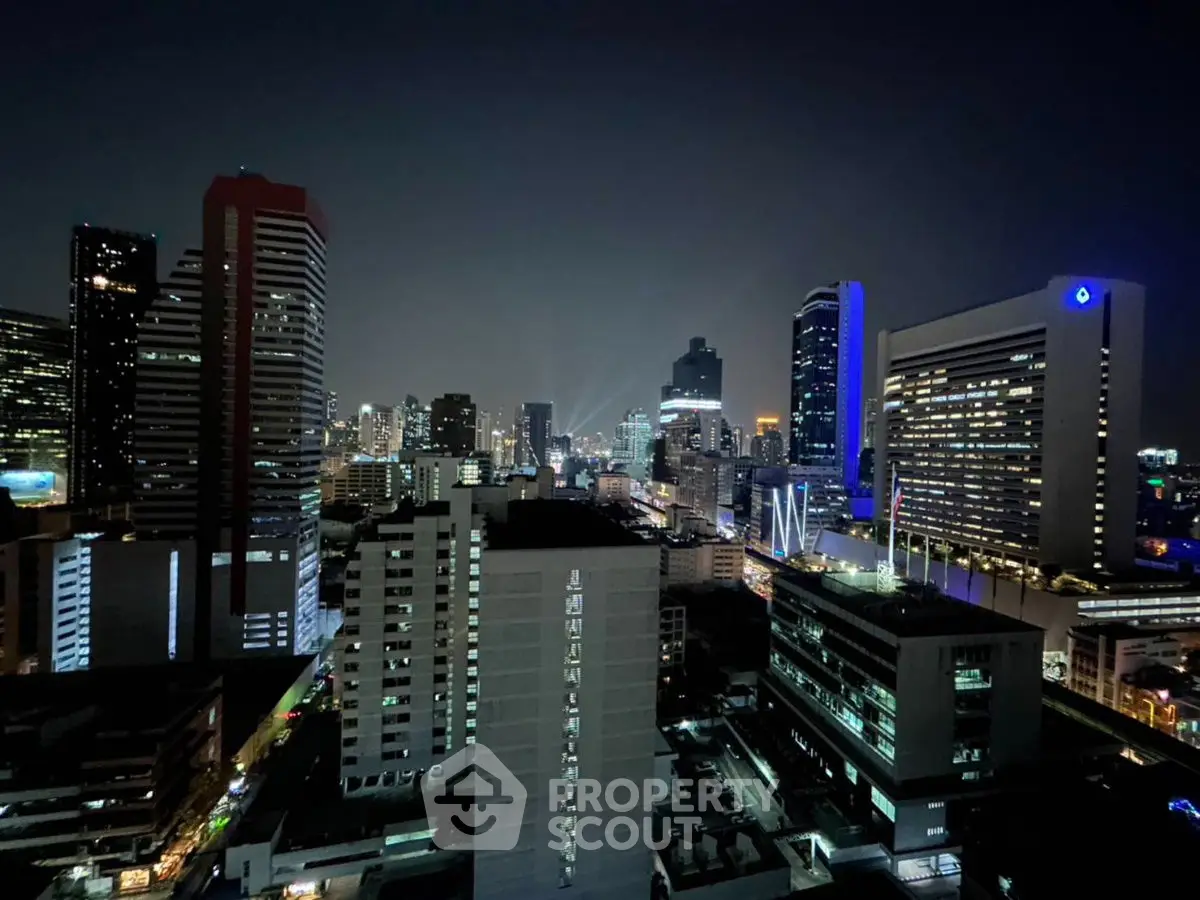 Stunning city skyline view at night with illuminated skyscrapers and vibrant city lights.