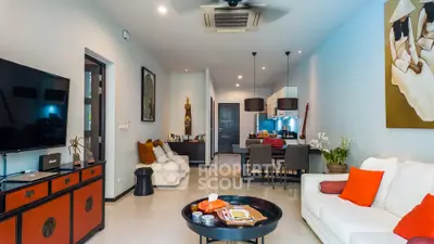 Stylish living room with modern decor and open layout, featuring a cozy seating area and elegant furnishings.
