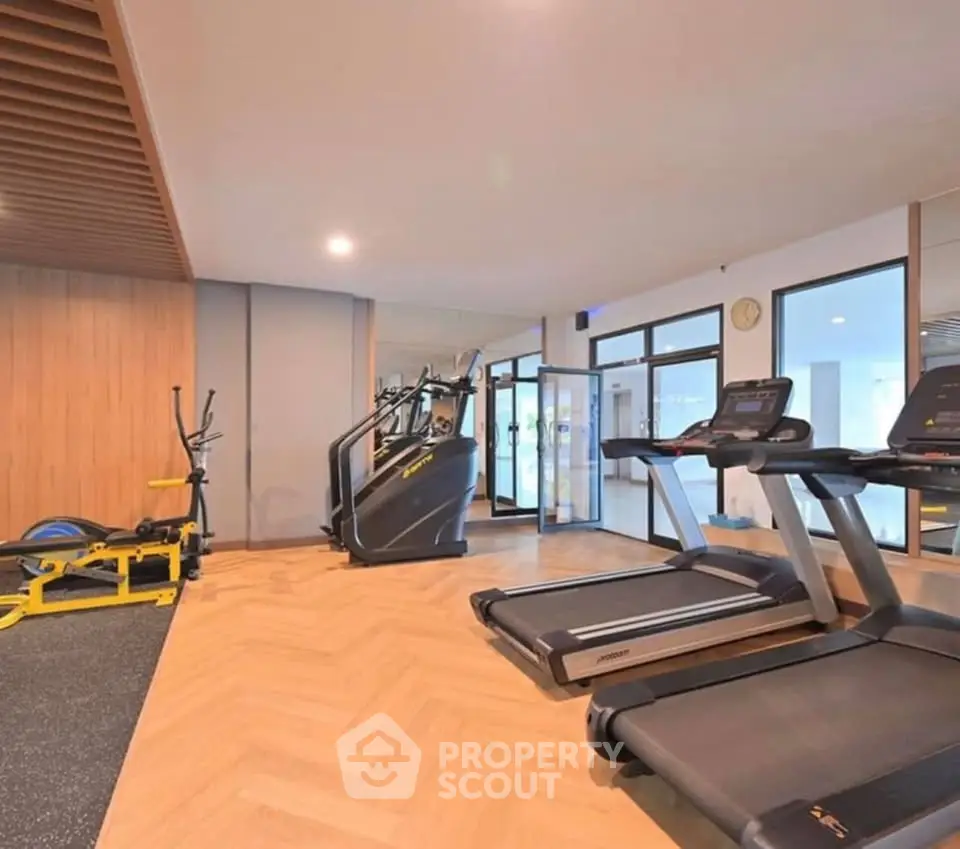 Modern gym with state-of-the-art equipment and stylish wooden accents.