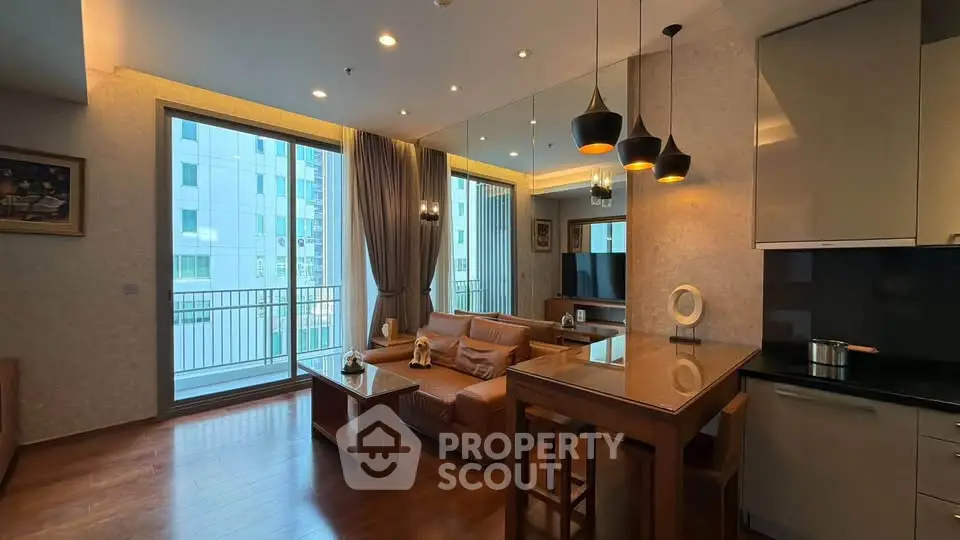 Modern living room with open kitchen and balcony view in luxury apartment