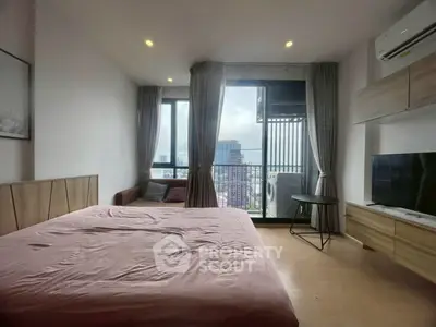 Modern bedroom with balcony view and stylish furnishings in urban apartment