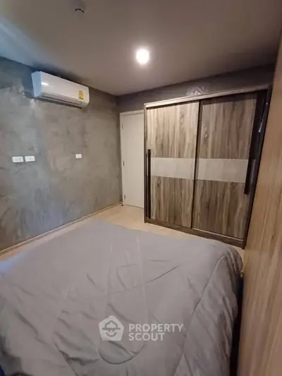 Modern bedroom with sleek wardrobe and air conditioning unit