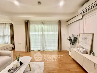 Spacious living room with modern decor and large windows for natural light.