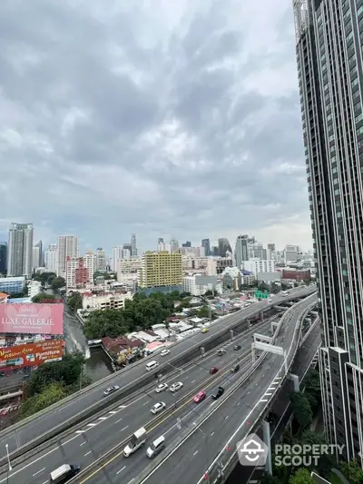 Stunning cityscape view from high-rise building with highway and skyline