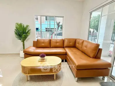 Modern living room with stylish brown leather sectional sofa and elegant coffee table.