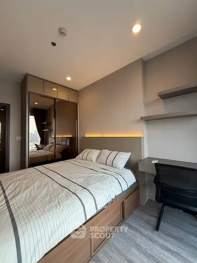 Modern bedroom with stylish decor, built-in wardrobe, and city view from window.