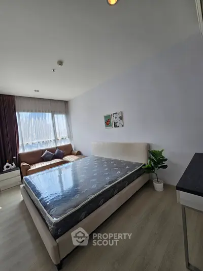 Modern bedroom with large window and stylish decor