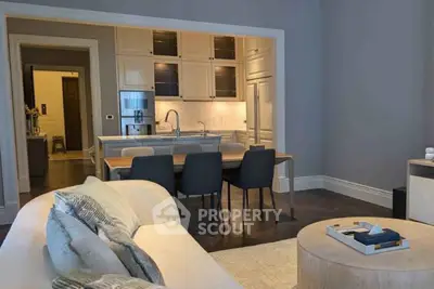 Modern open-layout living room with sleek kitchen and stylish decor