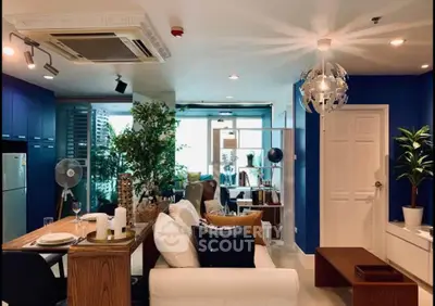 Modern living room with stylish decor, open layout, and large windows offering city views.