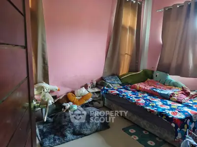 Cozy bedroom with colorful bedding and plush toys, perfect for a child's retreat.