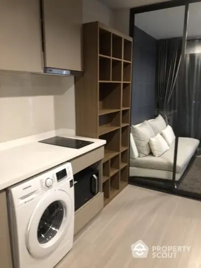 Modern compact kitchen with washing machine and open shelving