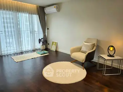 Spacious modern living room with elegant decor and large windows for natural light.