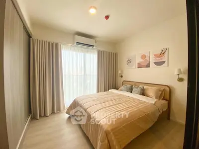 Cozy bedroom with modern decor and natural light, featuring a comfortable bed and stylish wall art.