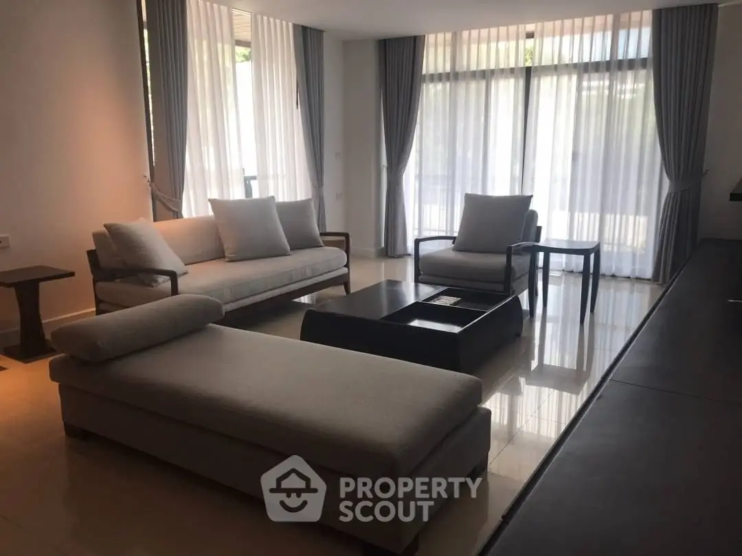 Elegant living room with modern furniture and large windows for natural light.